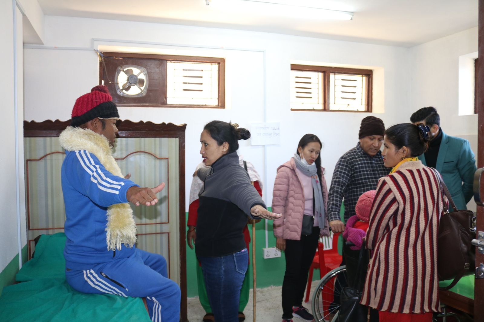 Health workers consulting with people with disabilities inside a health facility